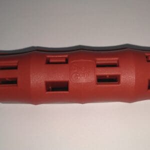 A red plastic tube with holes in it.
